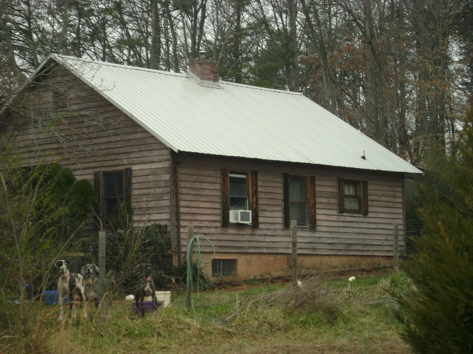 White metal roof on an old wood sided farmhouse, from a Asphalt Shingle Roof Repair job in Jefferson